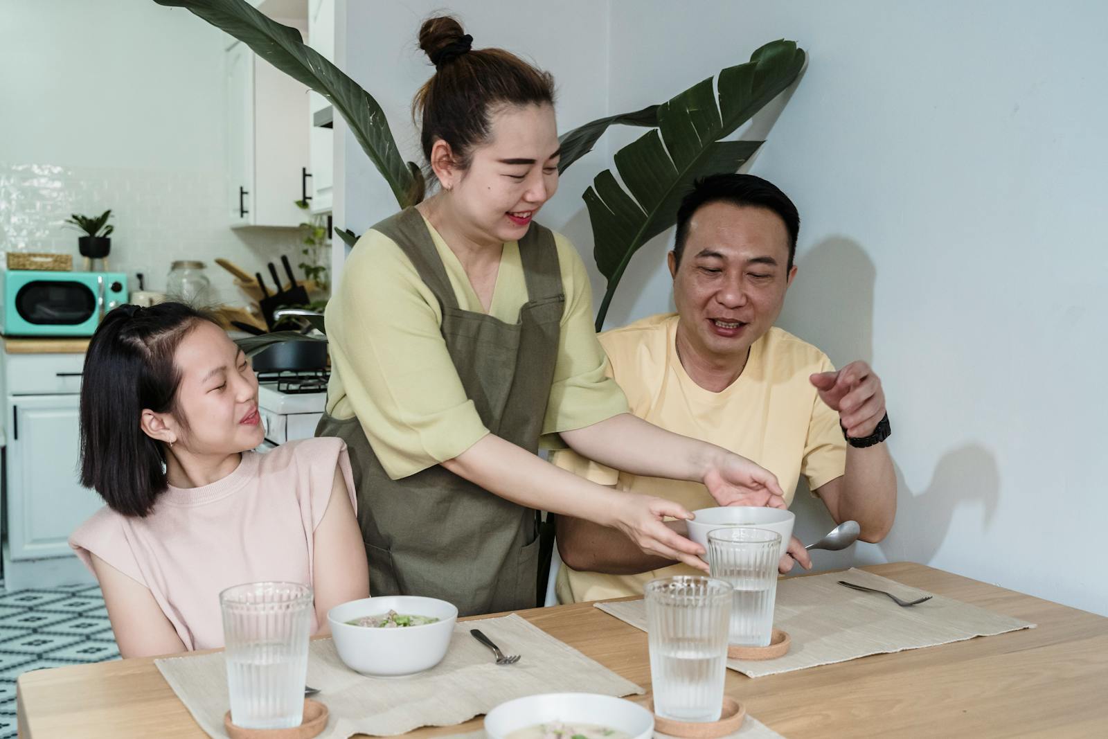 A live-in caretaker serving a family meal in a Singapore household